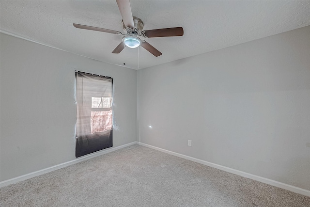 carpeted spare room featuring ceiling fan and a textured ceiling