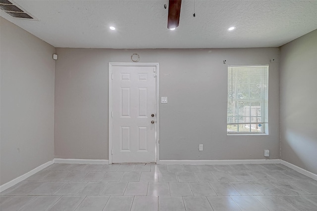 unfurnished room with a textured ceiling