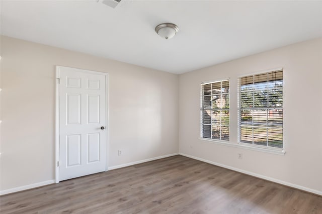 empty room with wood-type flooring