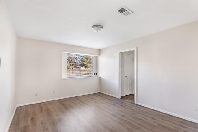 spare room with wood-type flooring