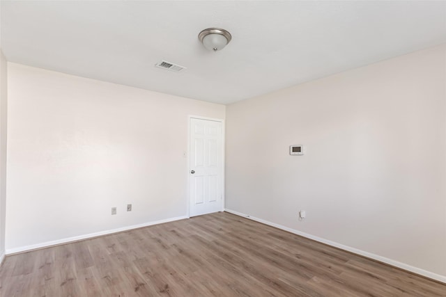 unfurnished room with light hardwood / wood-style flooring