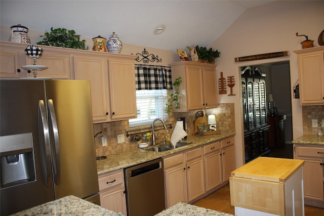 3011 Candle Bend Dr, Spring, TX 77388 - kitchen with tasteful backsplash, a sink, appliances with stainless steel finishes, light stone countertops, and vaulted ceiling