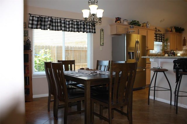 tiled dining space with sink and an inviting chandelier