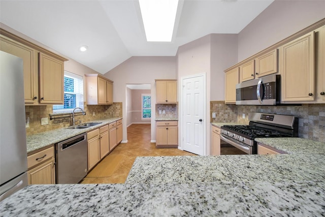 3011 Candle Bend Dr, Spring, TX 77388 - kitchen featuring stainless steel appliances, light brown cabinets, tasteful backsplash, light stone counters, and vaulted ceiling