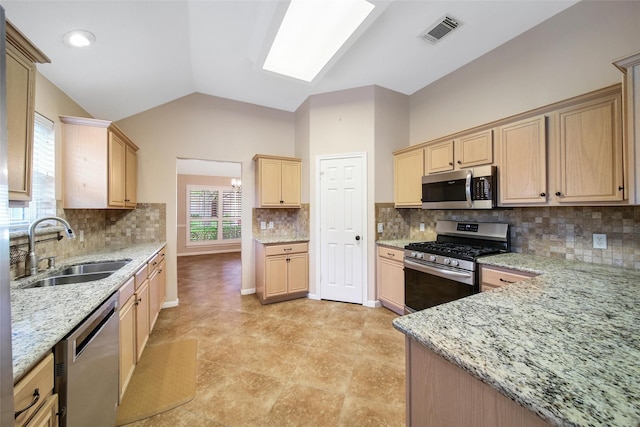 3011 Candle Bend Dr, Spring, TX 77388 - kitchen with stainless steel appliances, light brown cabinets, lofted ceiling, light stone countertops, and decorative backsplash