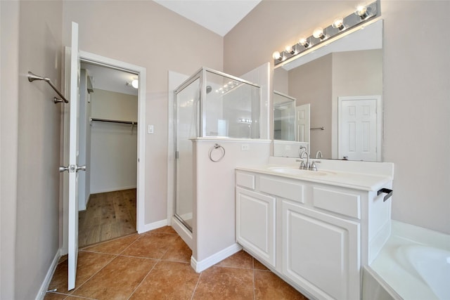 3011 Candle Bend Dr, Spring, TX 77388 - full bath featuring a shower stall, vanity, a spacious closet, tile patterned floors, and a tub to relax in