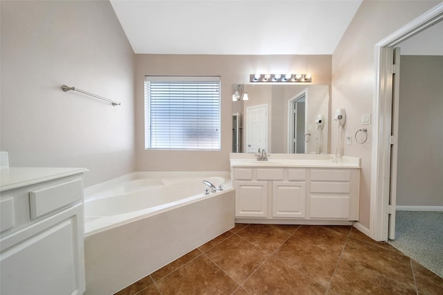 3011 Candle Bend Dr, Spring, TX 77388 - full bath with double vanity, a bath, vaulted ceiling, and tile patterned floors
