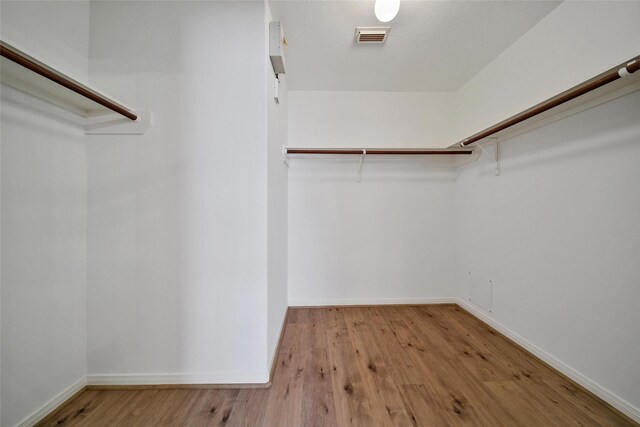 3011 Candle Bend Dr, Spring, TX 77388 - walk in closet with wood finished floors