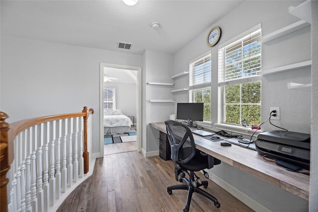 office space featuring hardwood / wood-style floors and a textured ceiling