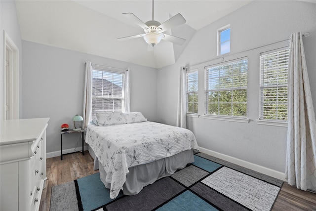 bedroom with lofted ceiling, dark hardwood / wood-style flooring, and ceiling fan