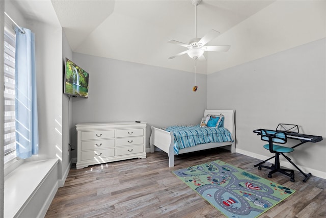 bedroom featuring ceiling fan, lofted ceiling, and hardwood / wood-style floors