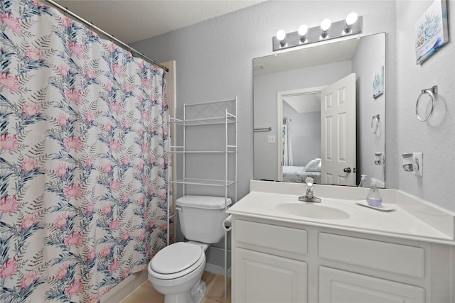 bathroom featuring vanity, curtained shower, and toilet