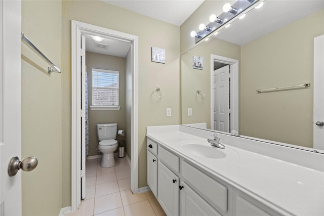 bathroom featuring tile patterned floors, vanity, and toilet