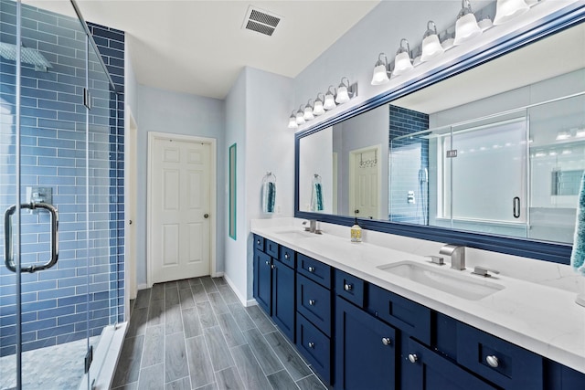 bathroom with vanity and an enclosed shower