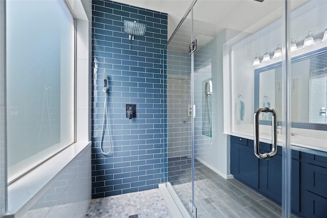 bathroom with vanity and a shower with shower door