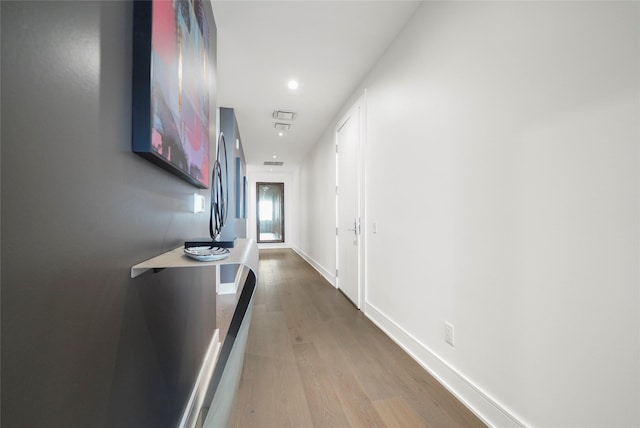 hallway with wood-type flooring