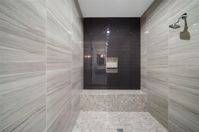 interior details with a tile shower