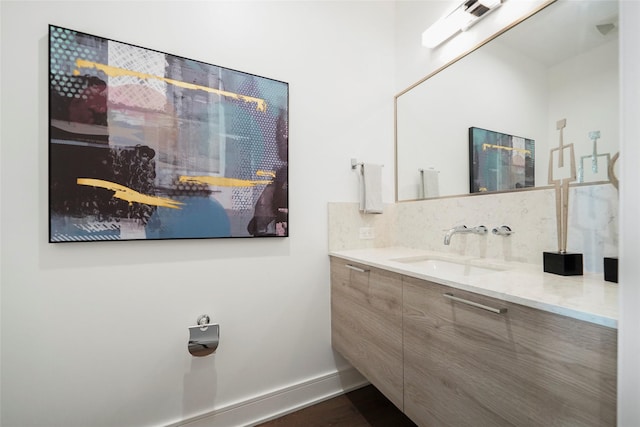 bathroom featuring vanity, backsplash, and hardwood / wood-style flooring