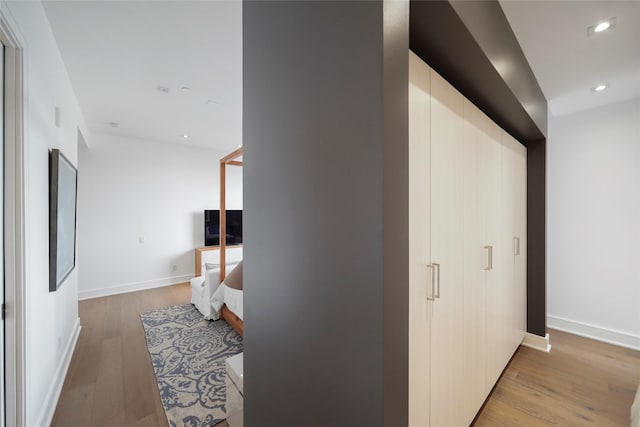 hallway with light hardwood / wood-style flooring