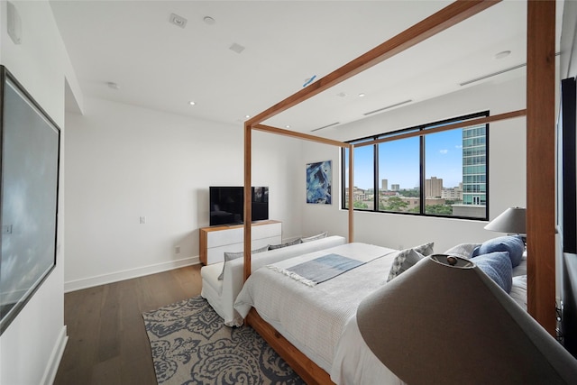 bedroom with dark hardwood / wood-style flooring