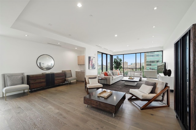 living room with hardwood / wood-style flooring and floor to ceiling windows