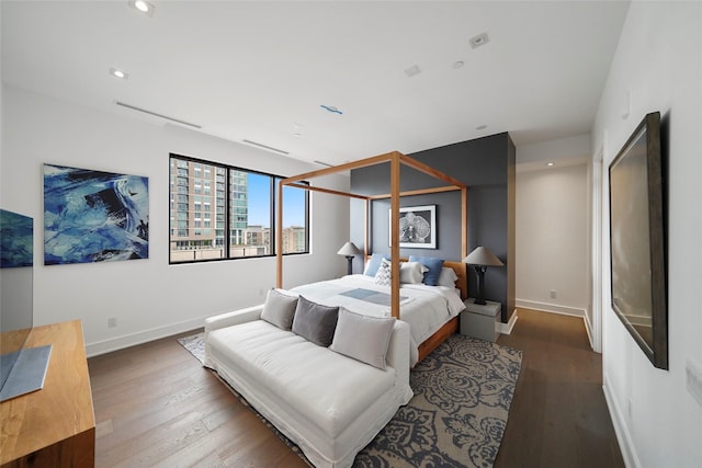 bedroom with dark hardwood / wood-style floors