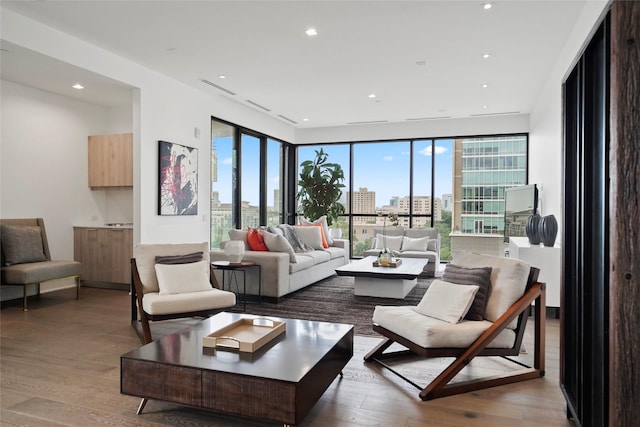 living room with wood-type flooring and floor to ceiling windows