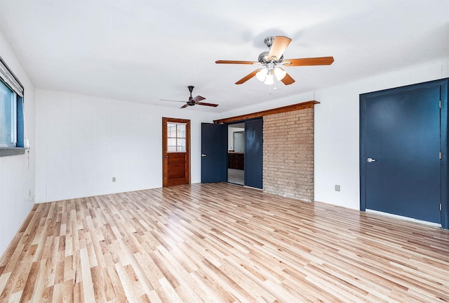 unfurnished living room with light hardwood / wood-style flooring and ceiling fan