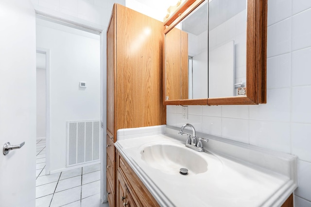 bathroom with tile patterned flooring, vanity, and decorative backsplash