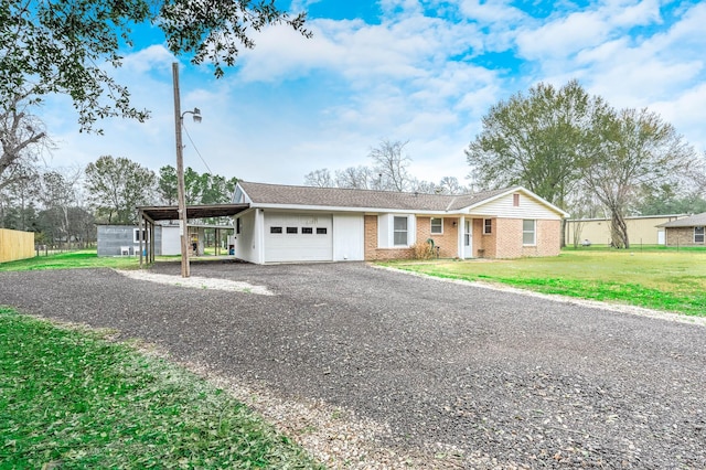 ranch-style house featuring a garage and a front lawn