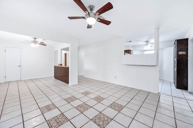 unfurnished living room featuring light tile patterned flooring and ceiling fan