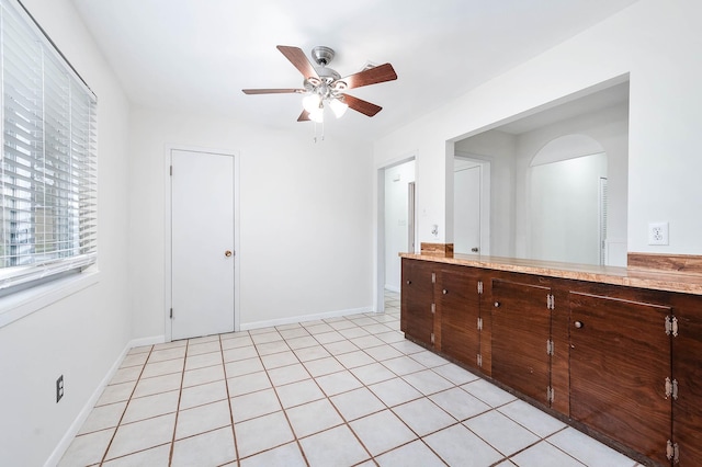 interior space featuring tile patterned floors and ceiling fan