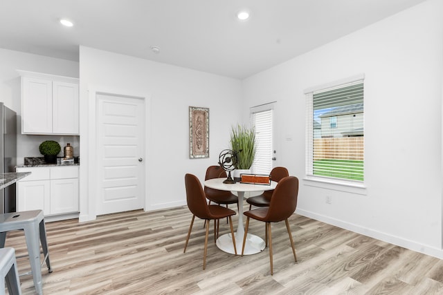 dining space with light hardwood / wood-style flooring