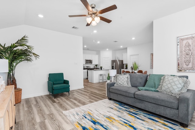 living room featuring ceiling fan and light hardwood / wood-style flooring