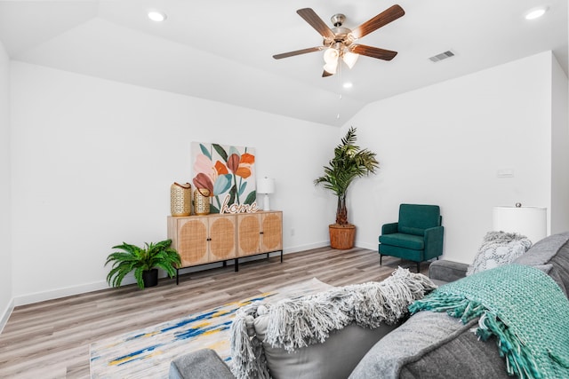 living room featuring ceiling fan, lofted ceiling, and light hardwood / wood-style flooring