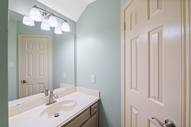 bathroom with vanity and vaulted ceiling