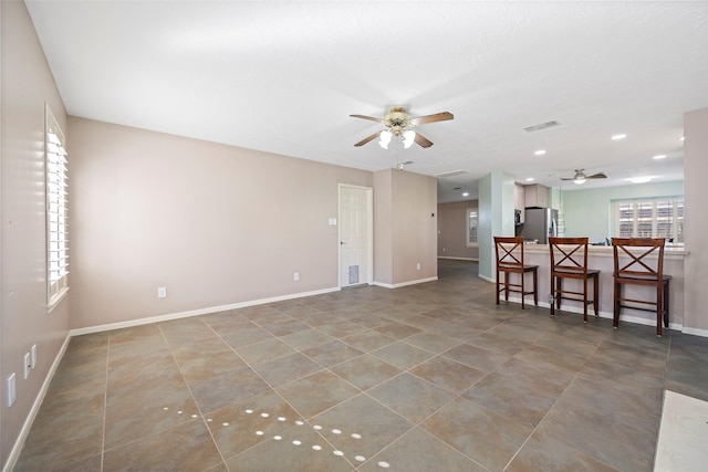 unfurnished living room featuring ceiling fan