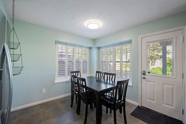 dining space with a healthy amount of sunlight and a textured ceiling