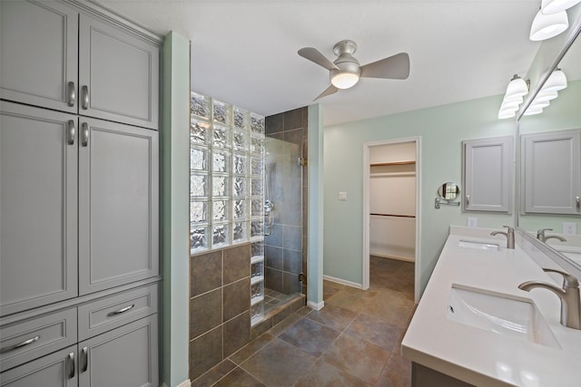 bathroom featuring walk in shower, ceiling fan, and vanity