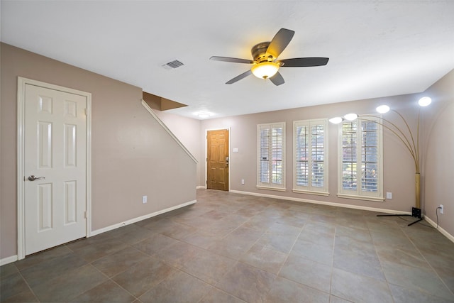 tiled empty room with ceiling fan