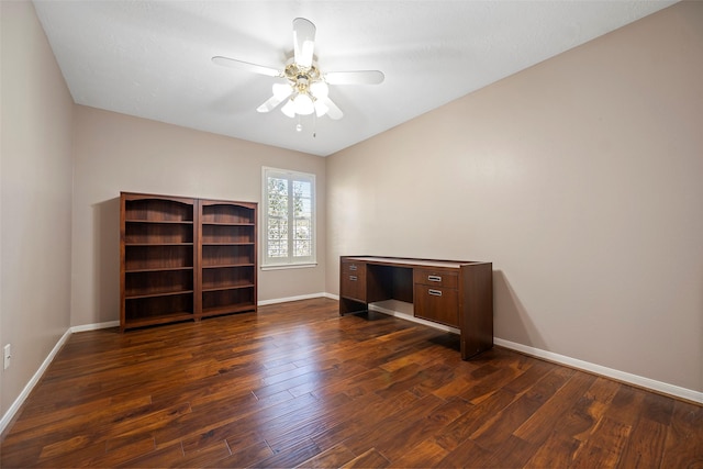 unfurnished office with ceiling fan and dark hardwood / wood-style flooring