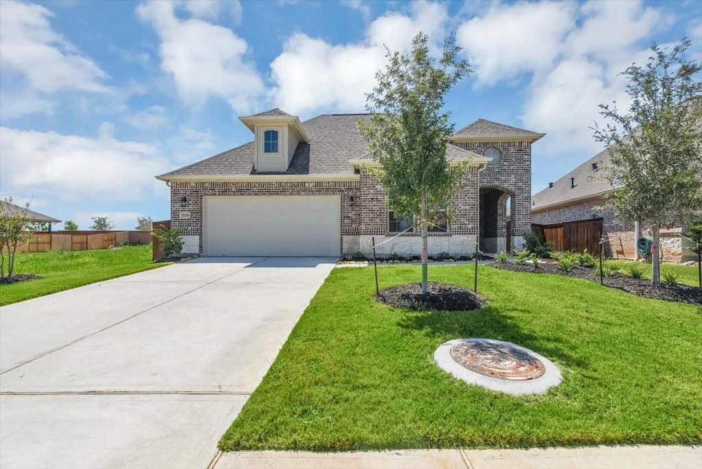 view of front of property featuring a garage and a front yard