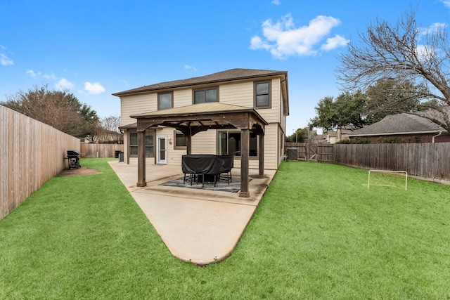 rear view of house featuring a gazebo, a patio, and a lawn