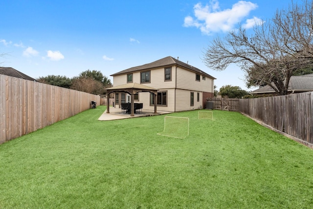 back of house featuring a patio, a gazebo, and a lawn