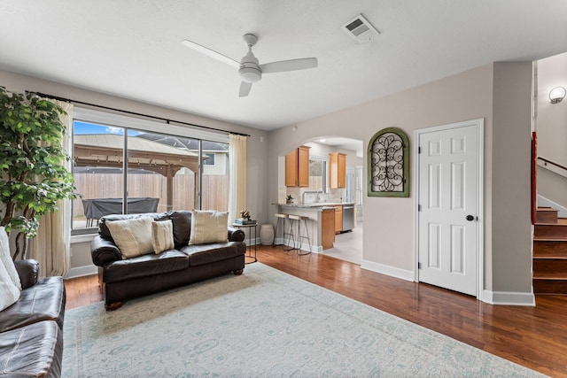 living room with sink, hardwood / wood-style floors, and ceiling fan