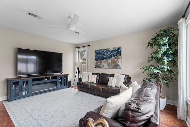 living room featuring ceiling fan and wood-type flooring