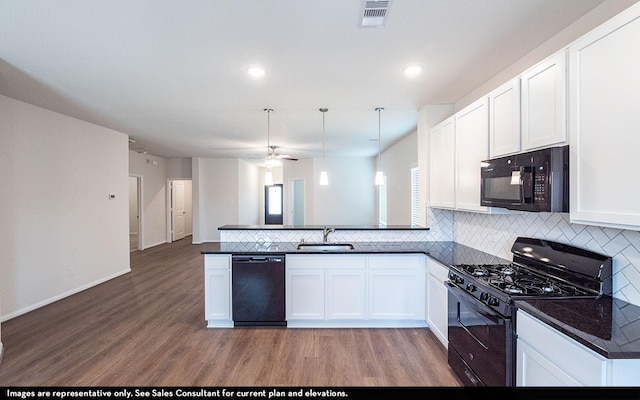 14119 Gingko Ct, Crosby, TX 77532 - kitchen with black appliances, a sink, light wood-style flooring, a peninsula, and recessed lighting