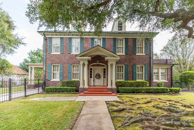 colonial-style house featuring a front lawn