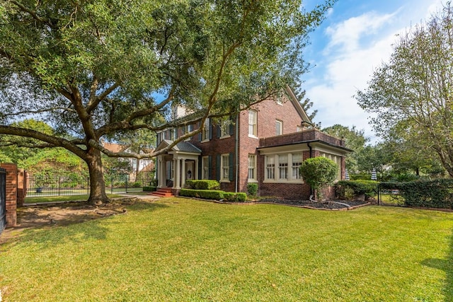 rear view of house featuring a lawn