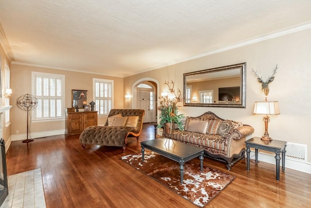 living room featuring hardwood / wood-style floors, crown molding, and a textured ceiling